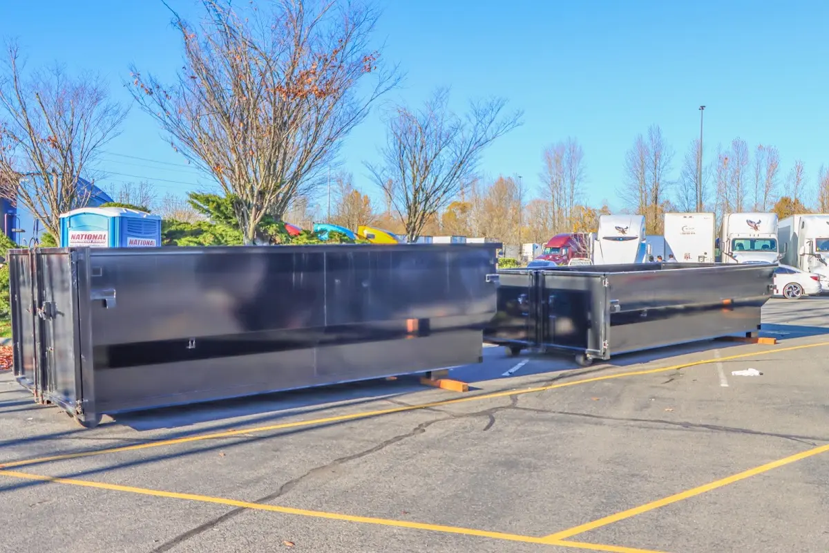 Professional dumpster rental service with roll-off container on residential driveway in Elkhart